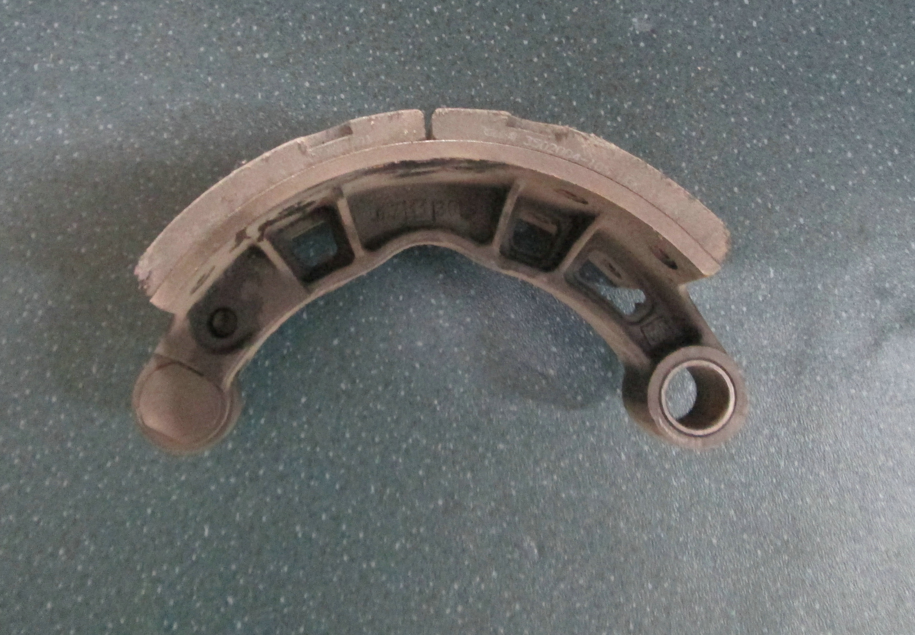 Rear brake shoe with friction plate and roller assembly