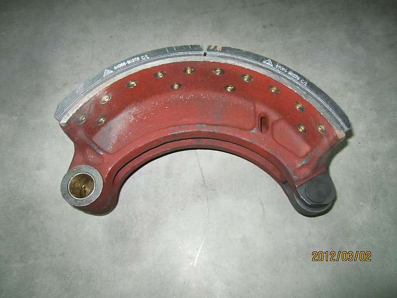 Brake shoe with friction plate and roller assembly