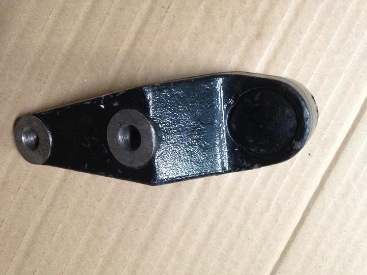 Front overhang twist arm assembly