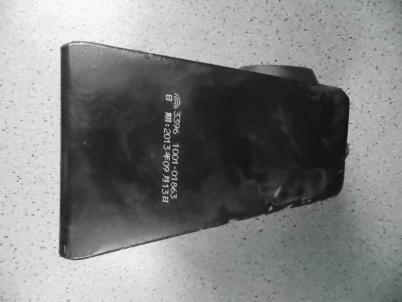 D The right rubber pad in front of the engine