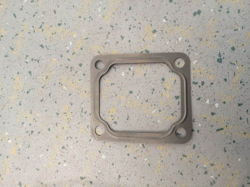 Cover gasket; right side of the rear end of the engine