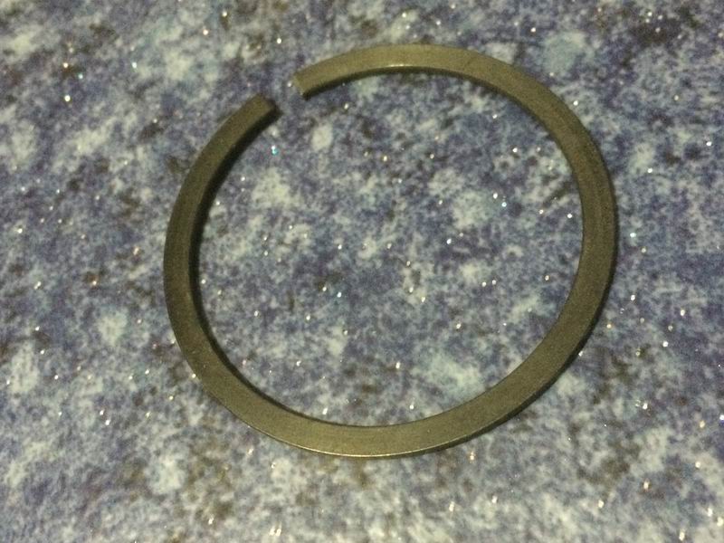 Flattened steel wire retaining ring for shaft