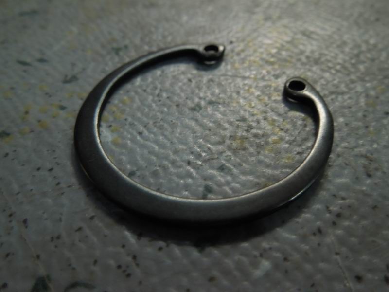 Cross shaft fixing spring