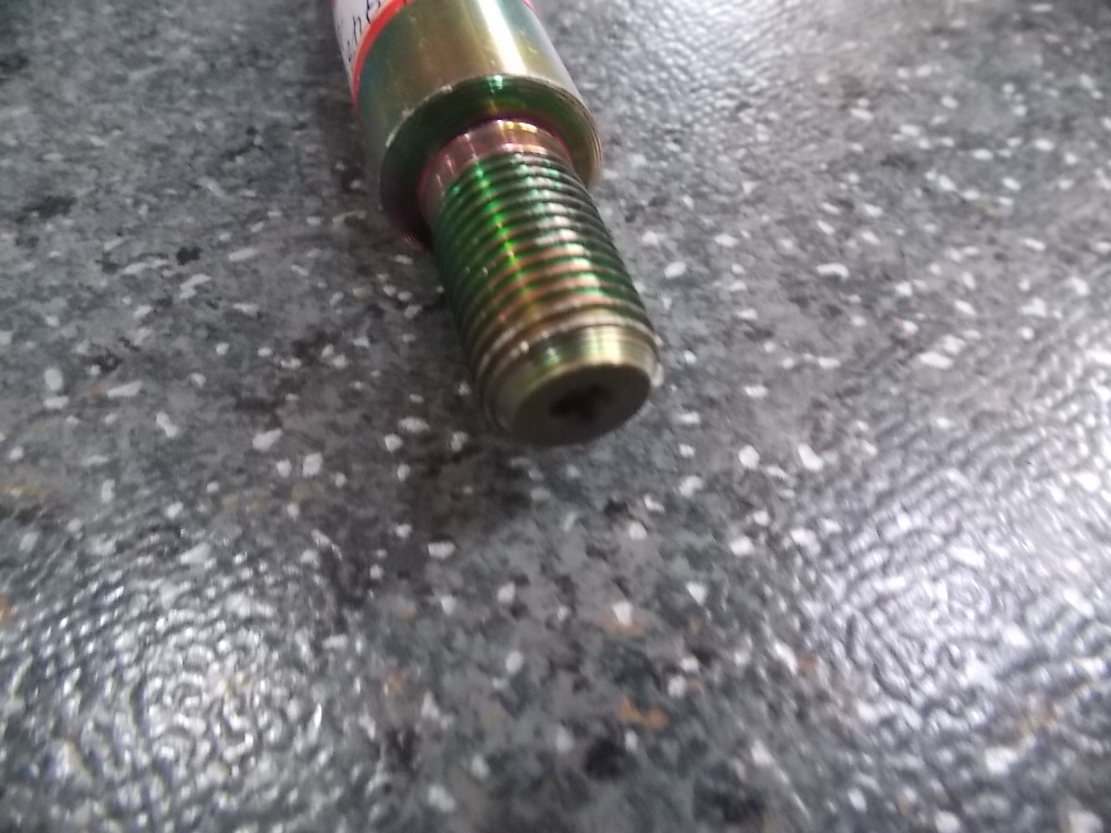 Rear shock absorber upper bracket shaft