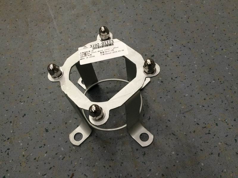 Behind the wheel cover bracket