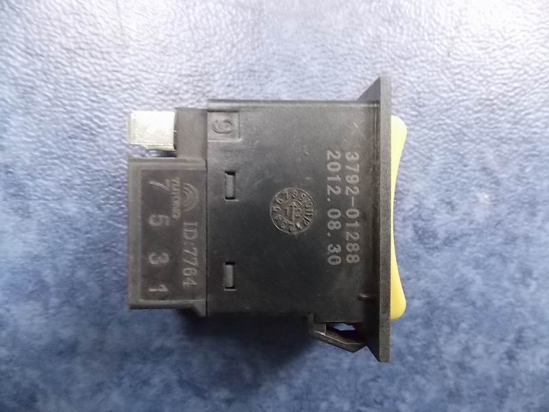 Right door main rocker switch (switch housing is yellow)