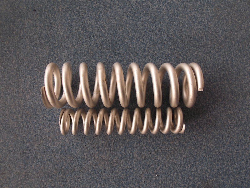 Compressor bracket spring; contains inner and outer springs
