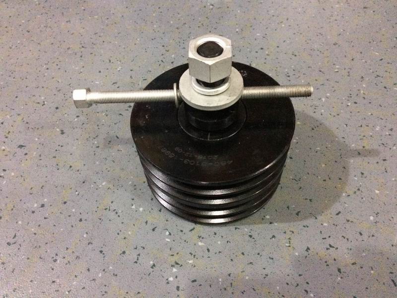 Air conditioner tensioner assembly